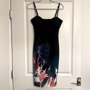 Beautiful Bebe dress size small with floral accent